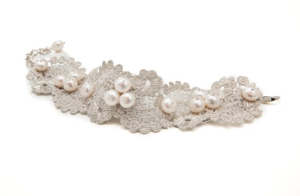Perlenschmuck auf zarter Spitze, elegant und verspielt gestaltet.